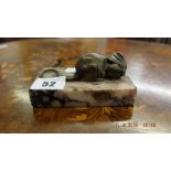 A small bronze sculpture of a mouse on a marble plinth,