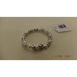 An 18ct white gold diamond and pearl spring bangle