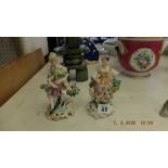 A pair of hand painted porcelain figures a/f