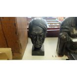 A bronzed cast bust of a historical figure