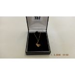 An 18ct gold diamond set pendant on 9ct chain