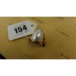 A pearl and yellow metal ring marked 750 size O weight 7 grams