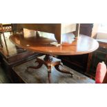 A Regency mahogany oval tilt top table on splayed base a.