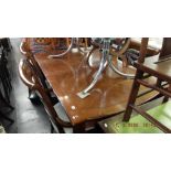 A contemporary extending dining table with two leaves,