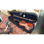 A cased students violin