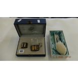 A boxed German 800 silver teacup holder with glass and matching silver napkin ring,