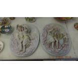 A pair of Meissen style wall plaques