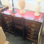 A mahogany pedestal desk with leather insert