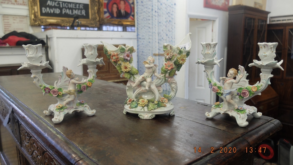 A pair of Meissen style candlearbras and another