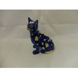 A French faience ware cat in the style of Emile Galle, with glass eyes,