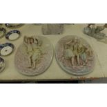 A pair of Meissen style wall plaques