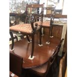 A mahogany Regency style table and six chairs with one leaf