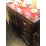 A mahogany pedestal desk with leather insert