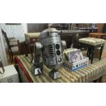 A cast metal log burner in form of R2 D2