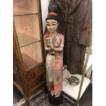 A carved wood oriental lady