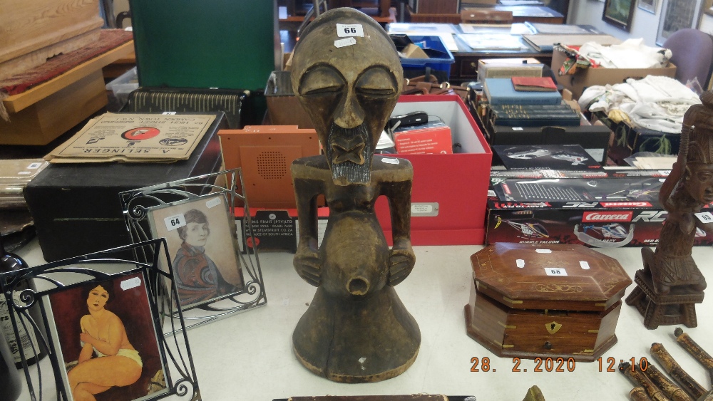 A carved standing African figure