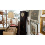 An art deco grandfather clock with pendulum weights and key