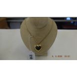 A yellow metal marked 750 heart pendent and chain weight 18 grams