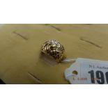 A yellow metal ring marked 750,