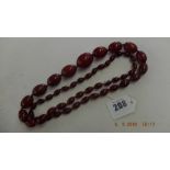 A cherry red faturan bead necklace