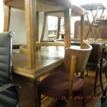 A walnut draw leaf table and six chairs