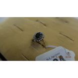 An 18ct gold sapphire and diamond cluster ring size K 1/2