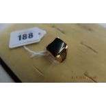 A yellow metal and onyx gentleman's ring weight 10 grams Size R