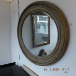 An oval gilt mirror
