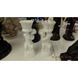 A pair of marble cherub candlesticks