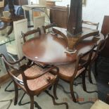 A mahogany Regency style table and six chairs with one leaf