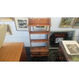 An upright small mahogany bookcase with four drawers