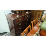 An Edwardian walnut chest of five drawers