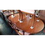 A mahogany Regency style table and six chairs with one leaf