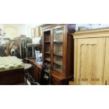 A Victorian walnut bookcase on cupboard base
