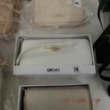 A DKNY white purse, leather, brand new unused, still has labels etc.