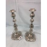 A hallmarked silver pair of candlesticks