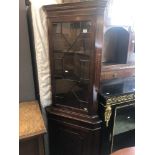 A mahogany corner cabinet