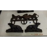 A pair of Victorian cast iron dog book ends and an early cast coat hanger