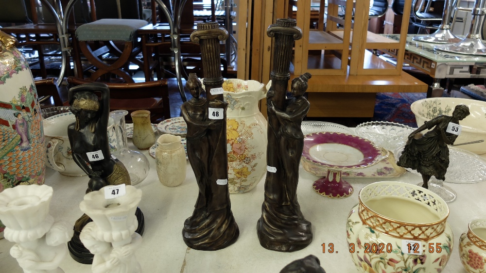 A pair of art deco style figural candle sticks