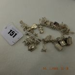 An early hm silver charm bracelet with 21 assorted very fine charms,