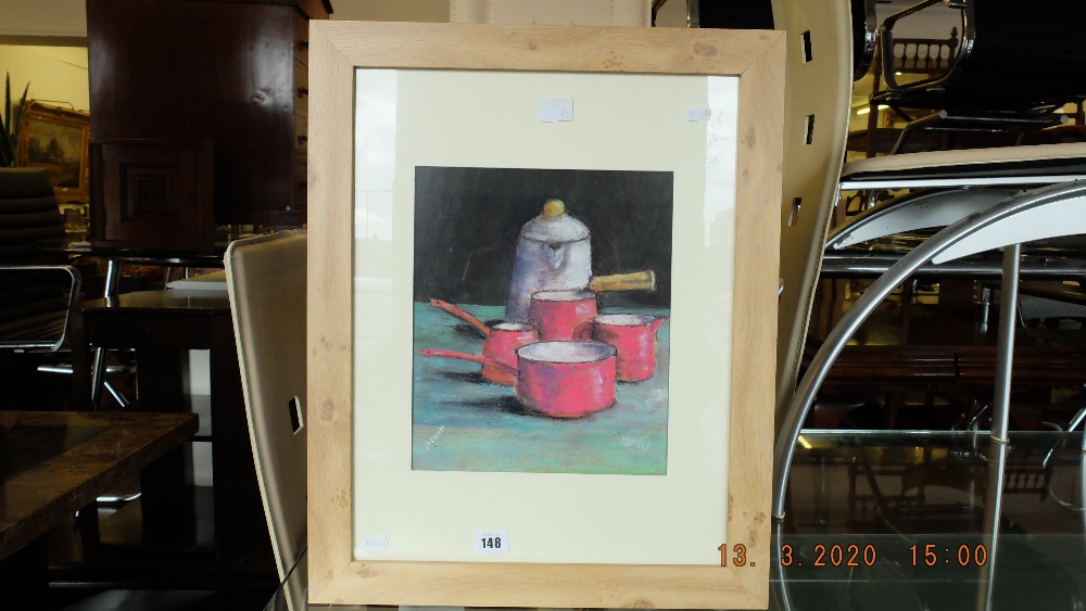 A framed pastel still life of pots and pans