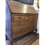 An oak bureau with three drawers