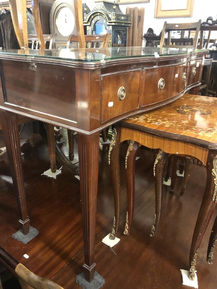 A mahogany serpentine sideboard