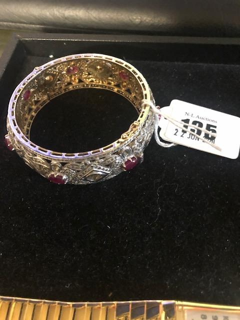 A 10ct diamond and ruby bangle