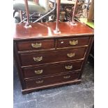 An Edwardian walnut chest of five drawers