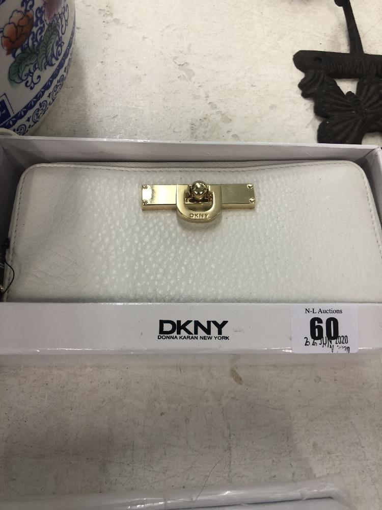 A DKNY white purse, leather, brand new unused, still has labels etc.