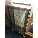 A Walnut single door display cabinet