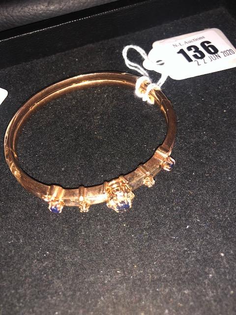 A 15ct gold ladies bangle set with sapphires and diamonds,