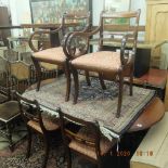 A mahogany Regency style table and six chairs with one leaf