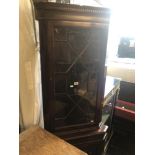 A mahogany corner cabinet